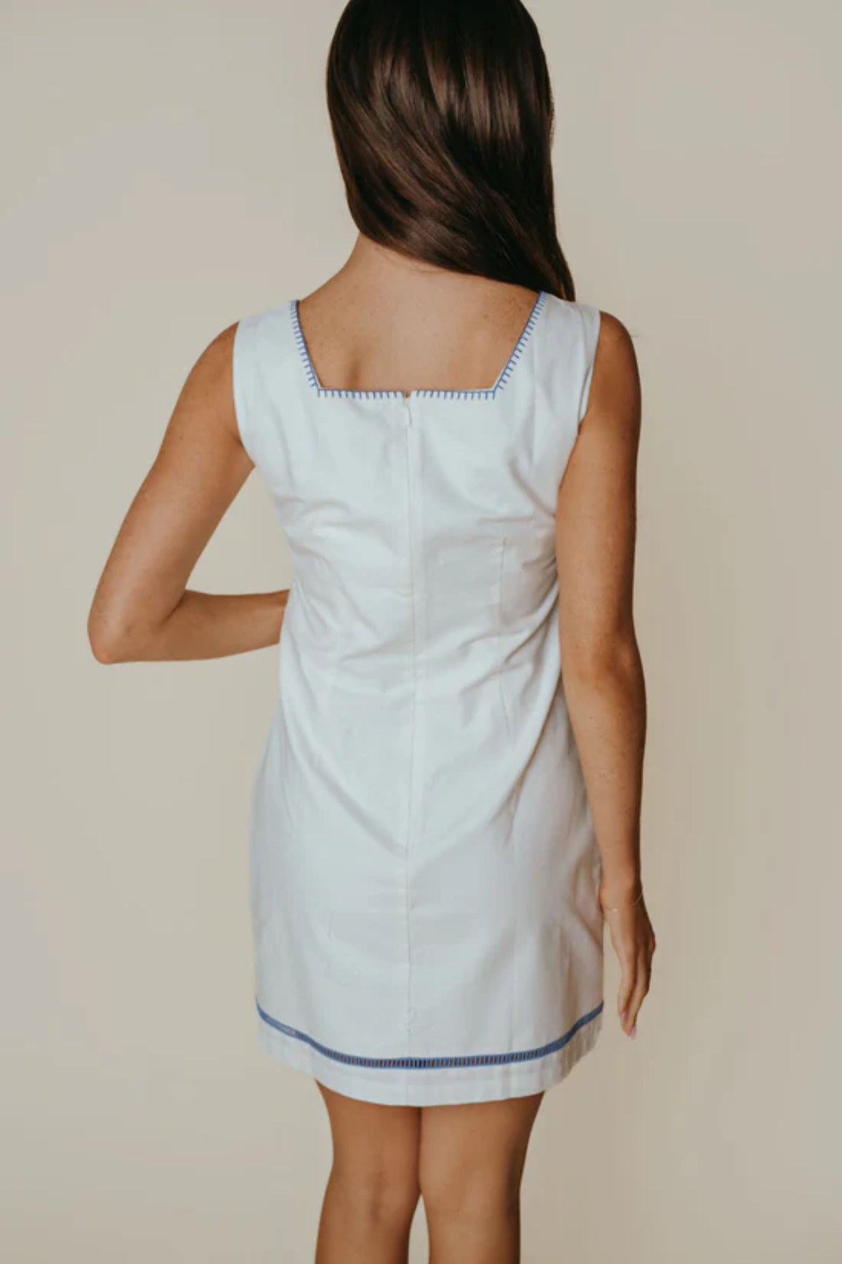 Woman wearing a light blue dress with a white background