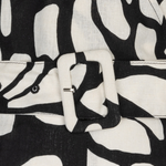 close up of black and white printed jumpsuit on white background 