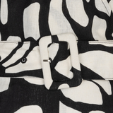 close up of black and white printed jumpsuit on white background 