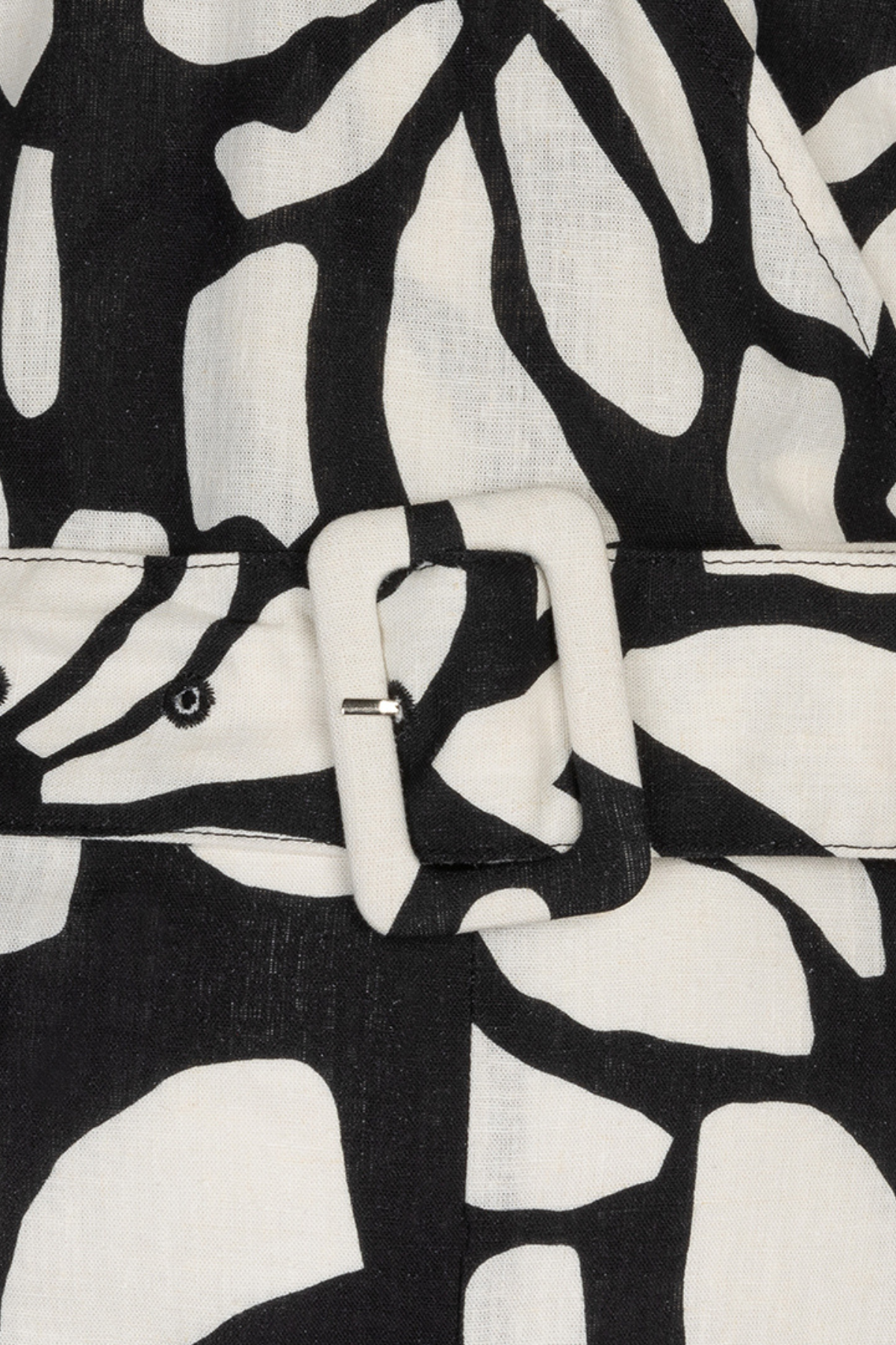 close up of black and white printed jumpsuit on white background 