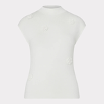 A white mock-neck knit top with cap sleeves, featuring small raised fabric flower embellishments on the front, displayed on a ghost mannequin against a light gray background.