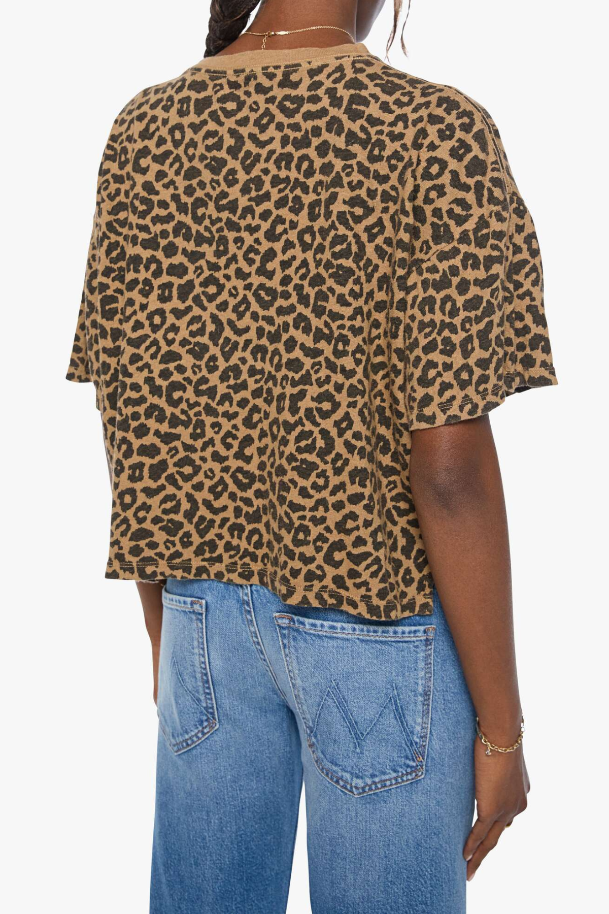 Model wearing a brown striped short-sleeve boxy ringer T-shirt with contrast trim and blue denim.