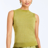A woman modeling a sleeveless knit top in olive green with matching satin pants, holding a brown clutch against a light gray studio background.