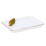 A rectangular white ceramic serving tray with a thin gold rim and the cursive text 'Olive you so much' printed in gold near one corner. Three green olives on a wooden pick are placed on the tray, which is photographed against a seamless white background.