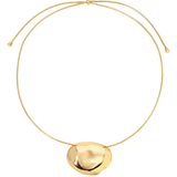 A gold adjustable cord necklace featuring a large, organic, polished disc-shaped pendant, displayed against a solid white background.