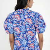 printed blue short sleeve top modeled against white background