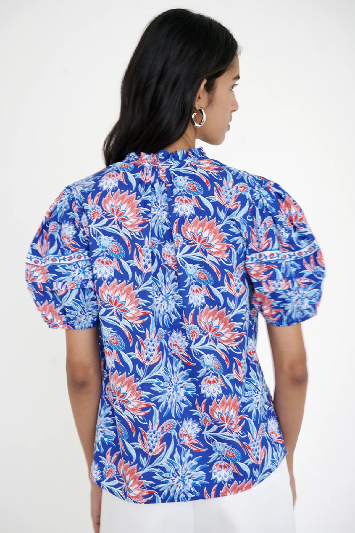 printed blue short sleeve top modeled against white background