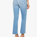 Light blue jeans worn by a person on a white background