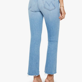 Light blue jeans worn by a person on a white background