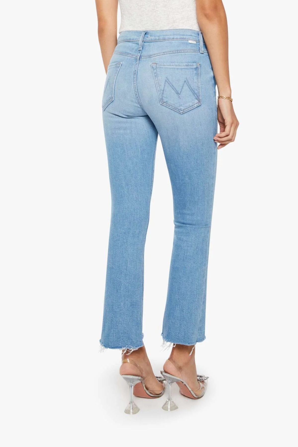Light blue jeans worn by a person on a white background