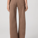 Person wearing brown wide-leg pants on a plain background