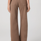 Person wearing brown wide-leg pants on a plain background