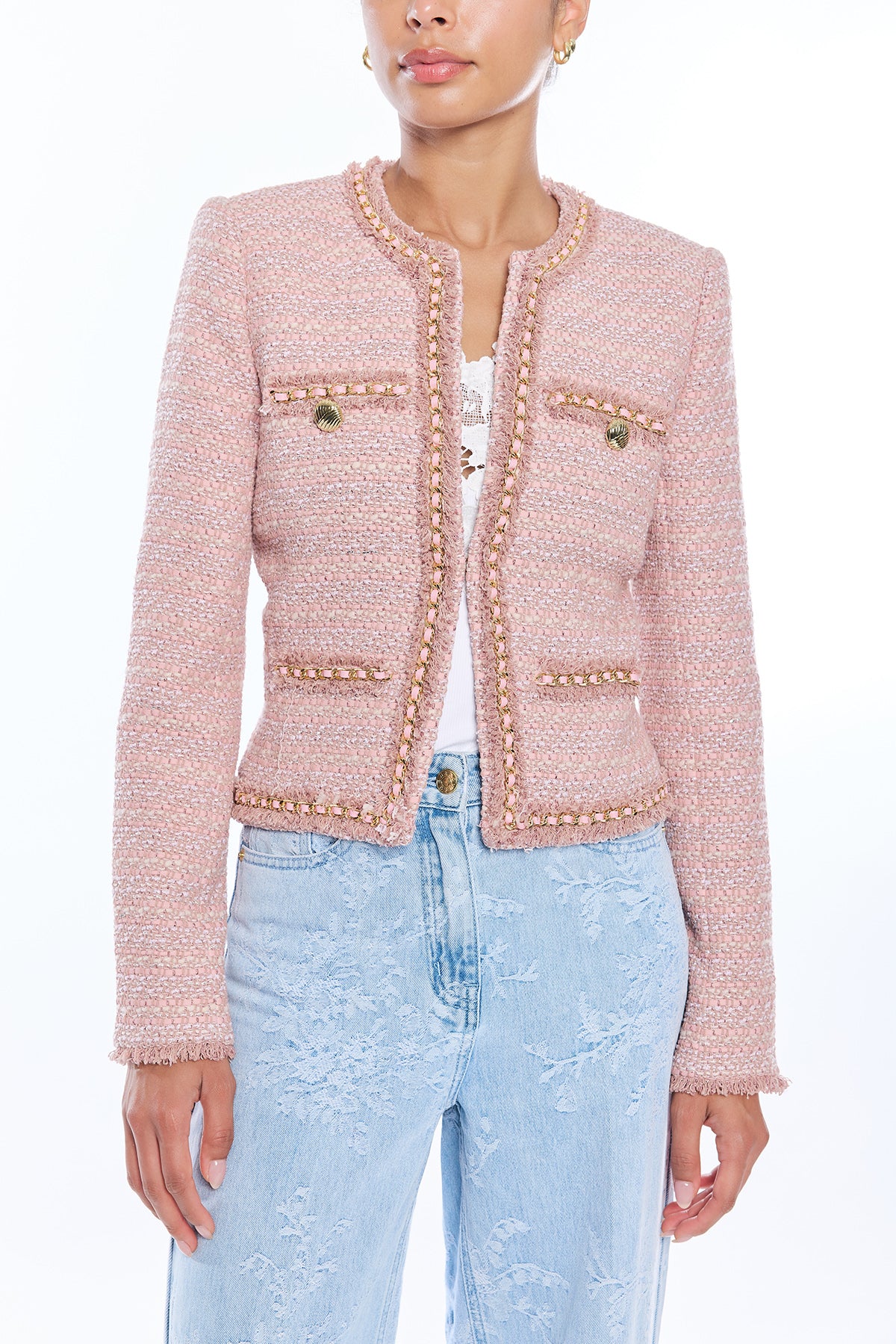 woman in blush pink tweed jacket on white background 