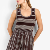 Model wearing a sleeveless fitted tank top with a classic neckline and streamlined silhouette.