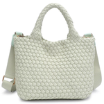 Light green woven handbag on a white background