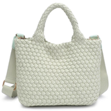 Light green woven handbag on a white background
