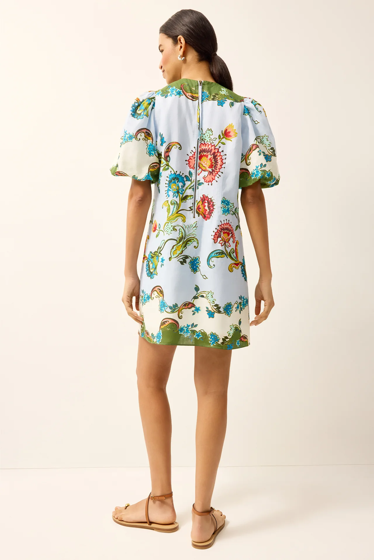 Woman wearing a floral dress on a white background