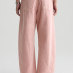 Person wearing pink wide-leg pants on a plain background