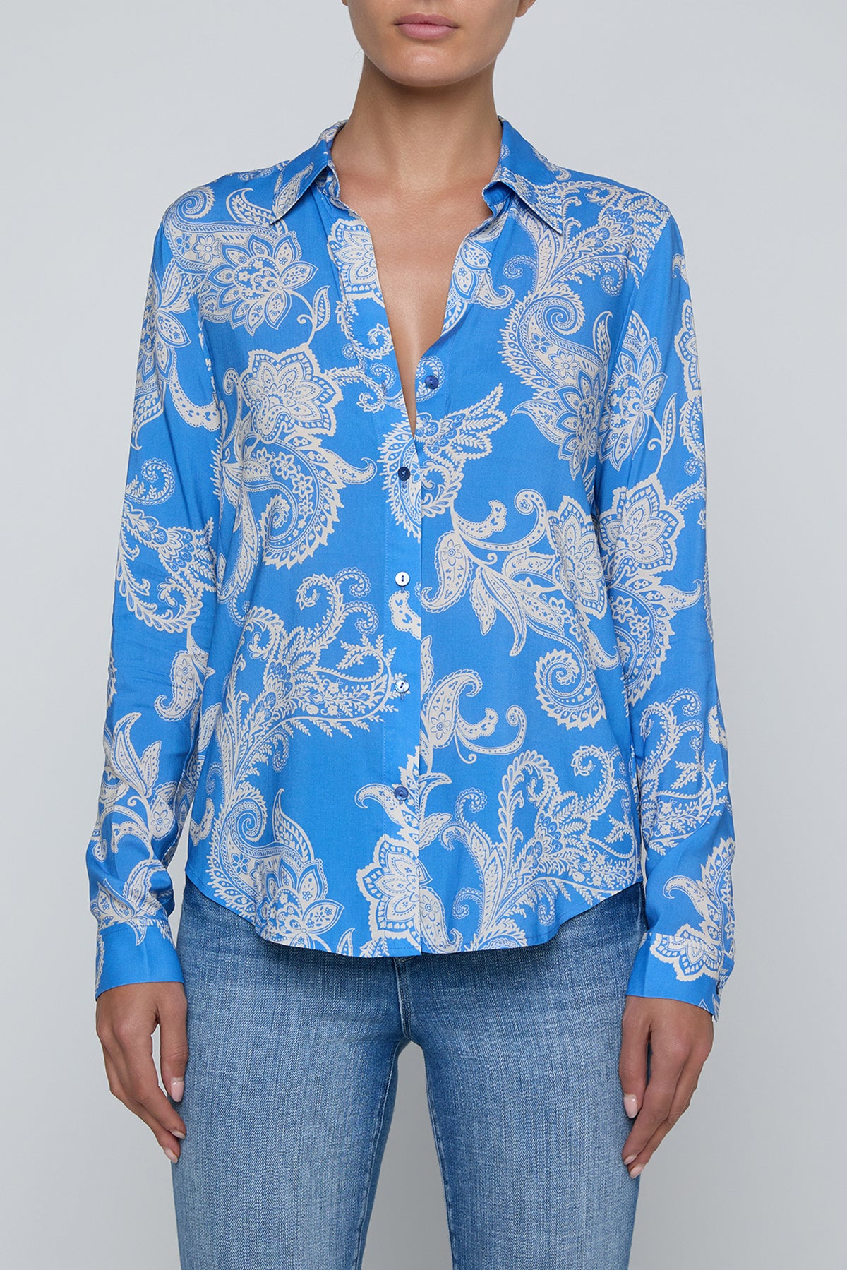 Long-sleeve blouse with fluid drape in a vibrant blue print.