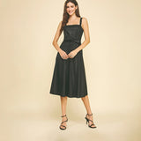 Black faux leather midi dress with button detailing.