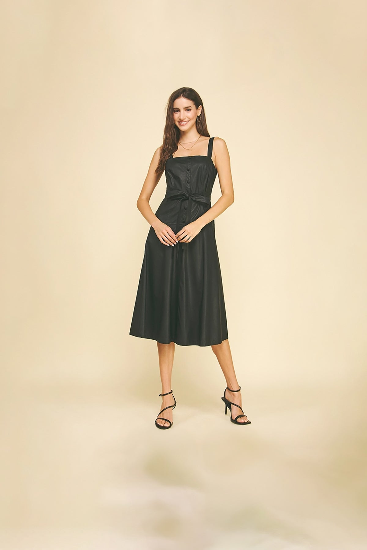 Black faux leather midi dress with button detailing.