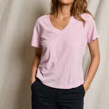 woman in pink t-shirt on draped background 