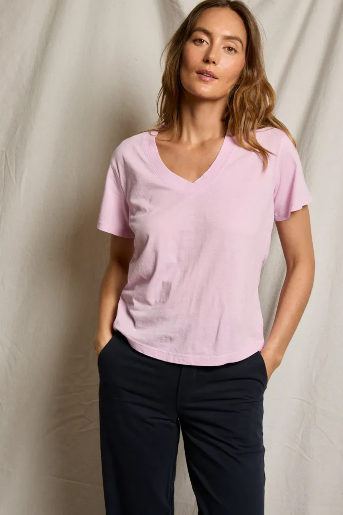 woman in pink t-shirt on draped background 