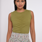 Model wearing an olive green sleeveless knit tank.