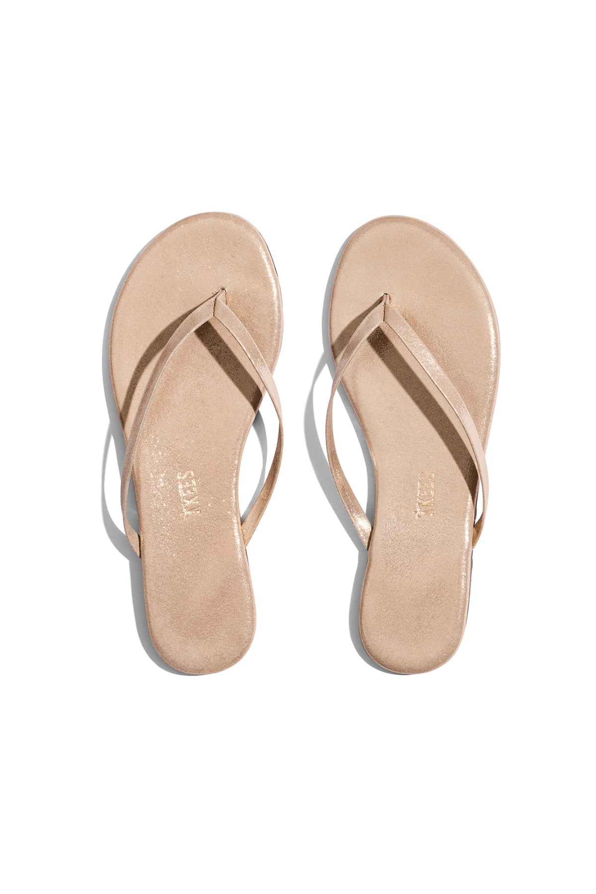 Pair of beige flip-flops on a white background