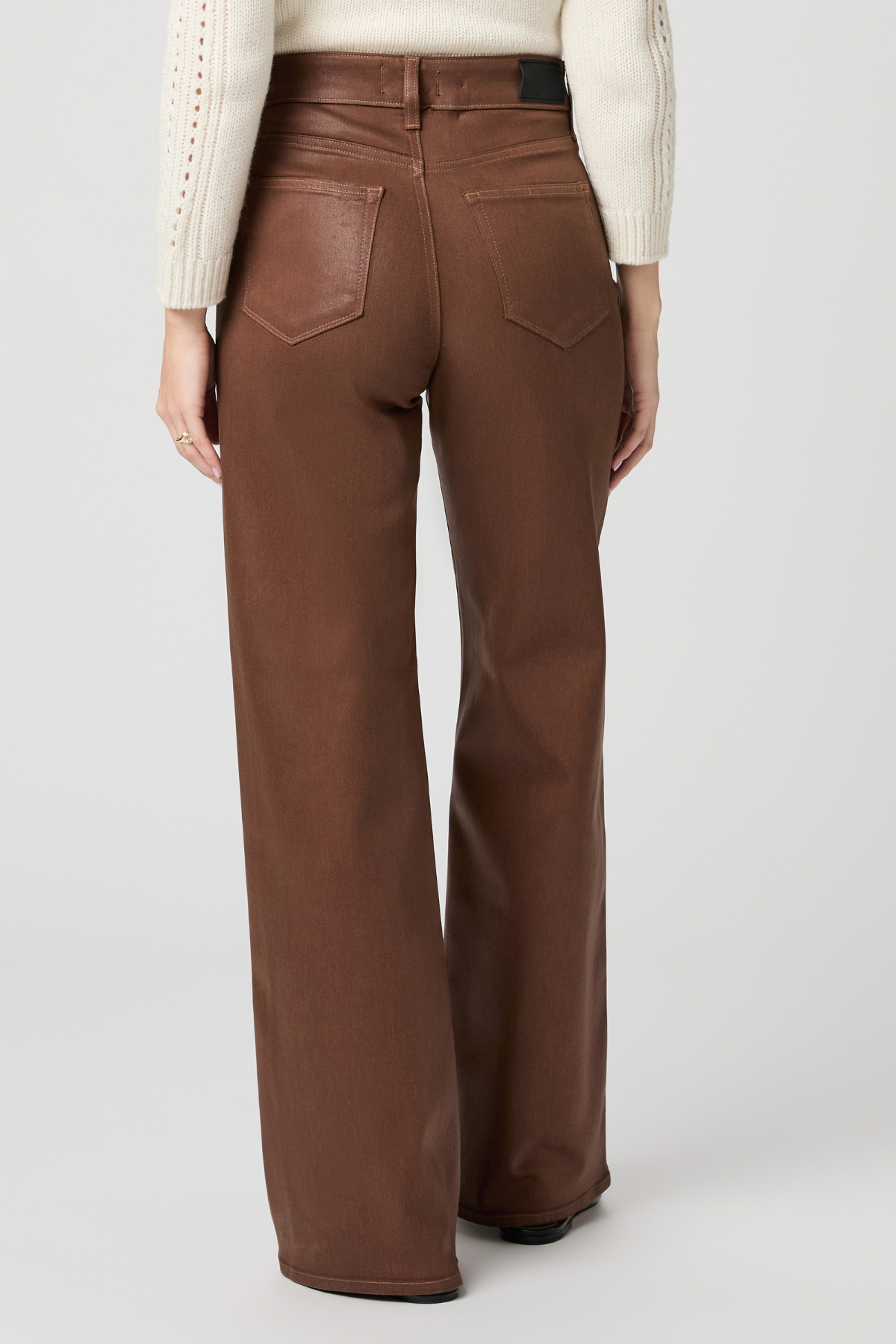 Women's cognac coated Anessa jeans featuring a high rise, 31-inch inseam, and wide-leg silhouette.