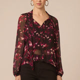 Woman wearing a floral blouse with a beige background