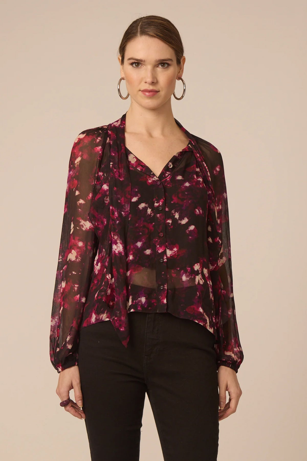 Woman wearing a floral blouse with a beige background