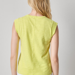 back of woman in yellow sleeveless top on white background 