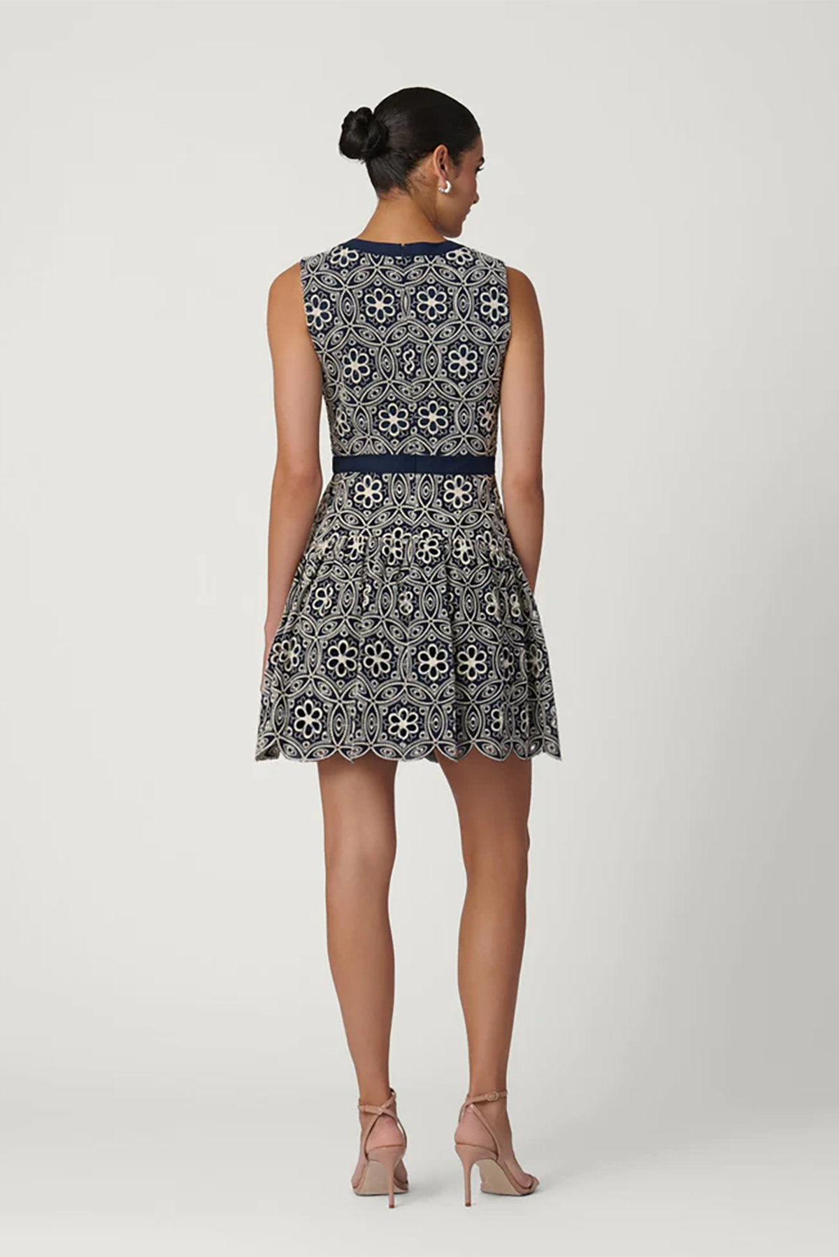 Woman wearing a patterned dress on a white background