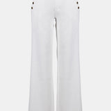 White pants with decorative buttons on a white background