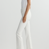 Person wearing a white outfit with high-waisted pants on a light gray background