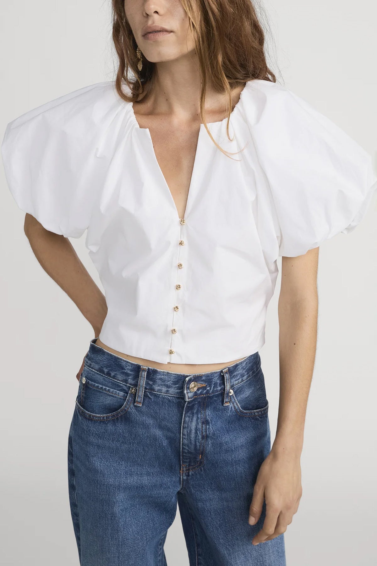 Blouse with dramatic voluminous sleeves styled with denim