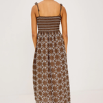 Woman wearing a patterned dress on a white background