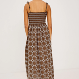 Woman wearing a patterned dress on a white background