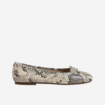 White sneaker with brown sole on a beige background