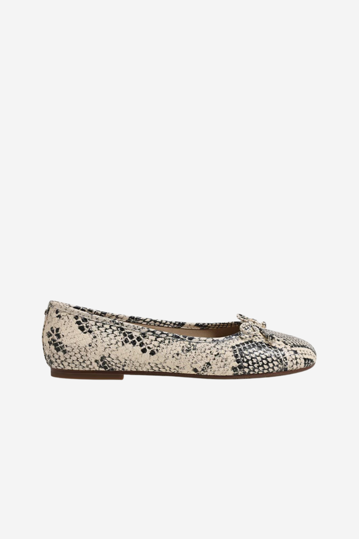 White sneaker with brown sole on a beige background