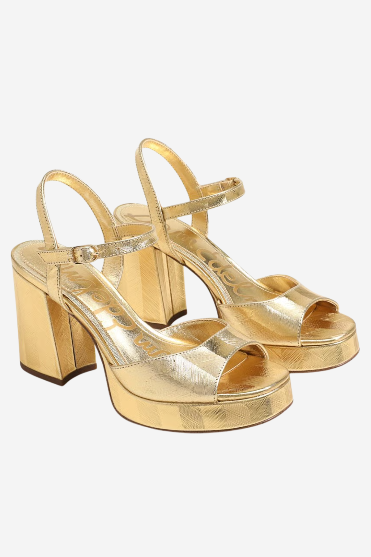 A pair of metallic gold platform block-heel sandals with open toes and ankle straps, shown on a light gray background.