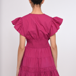 Model wearing a bright pink mini dress with a fitted waist and short sleeves.