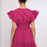 Model wearing a bright pink mini dress with a fitted waist and short sleeves.