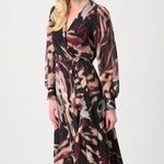 Woman wearing a long, patterned dress on a white background