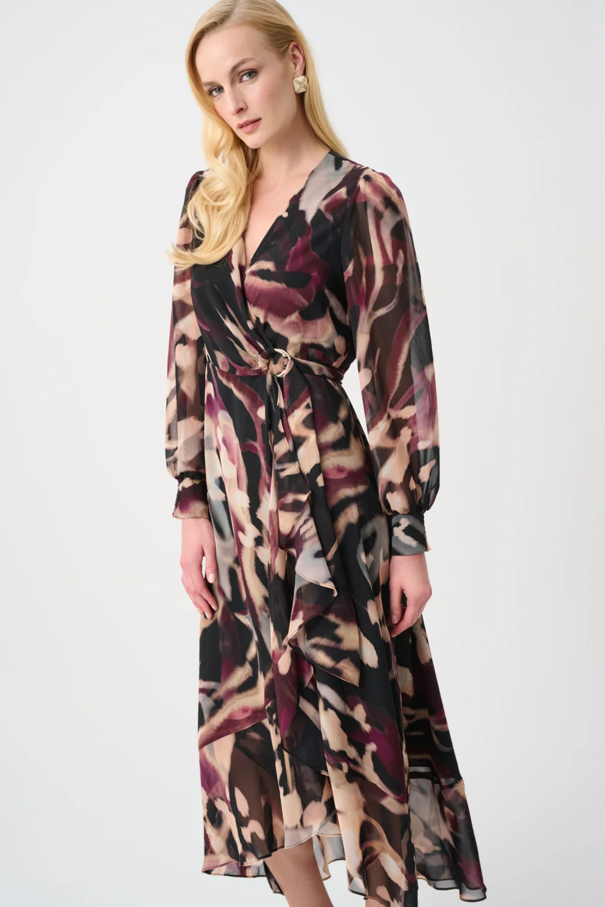 Woman wearing a long, patterned dress on a white background