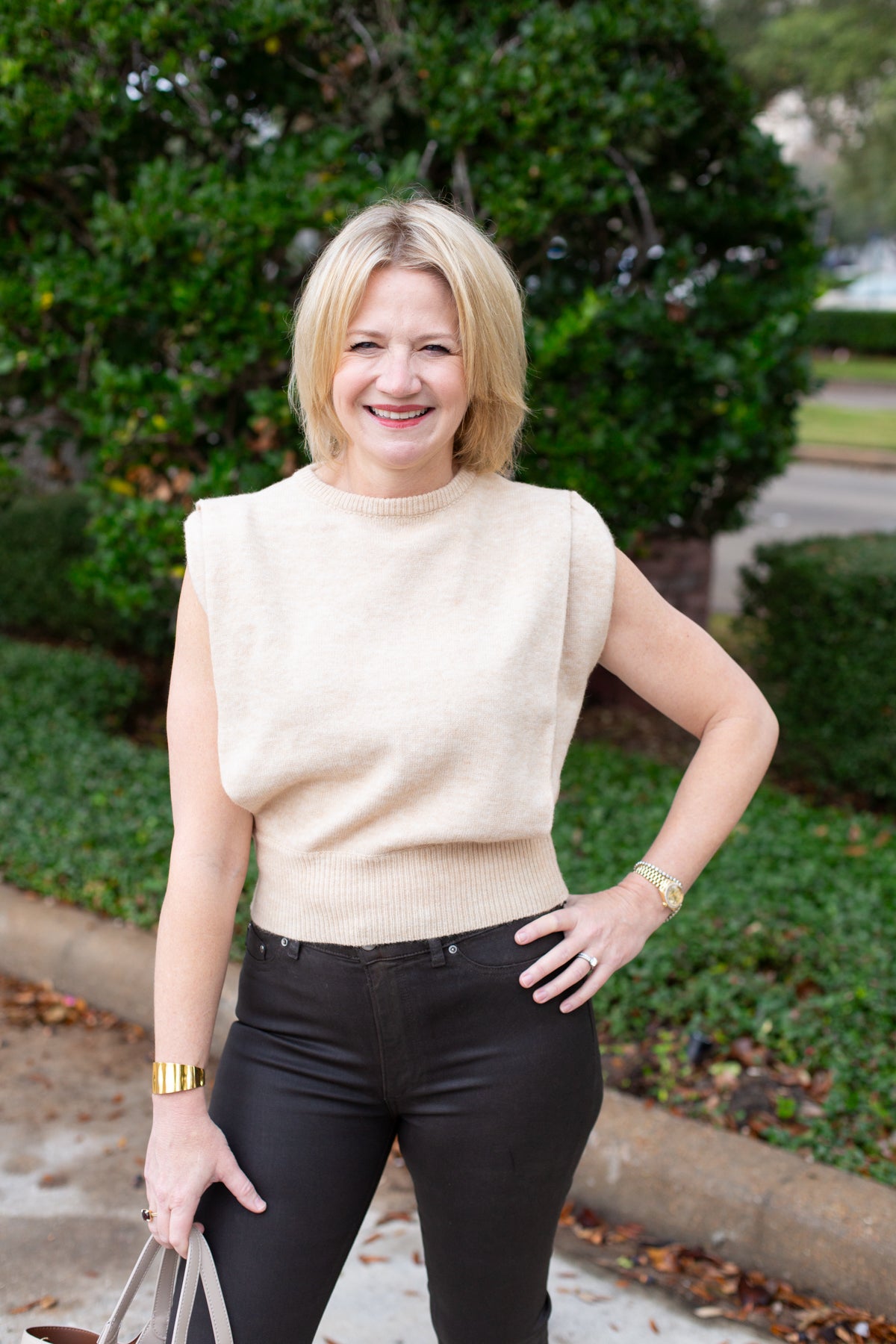 Sleeveless knit muscle sweater vest styled with trousers