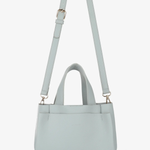 Light blue handbag with a matching strap on a white background