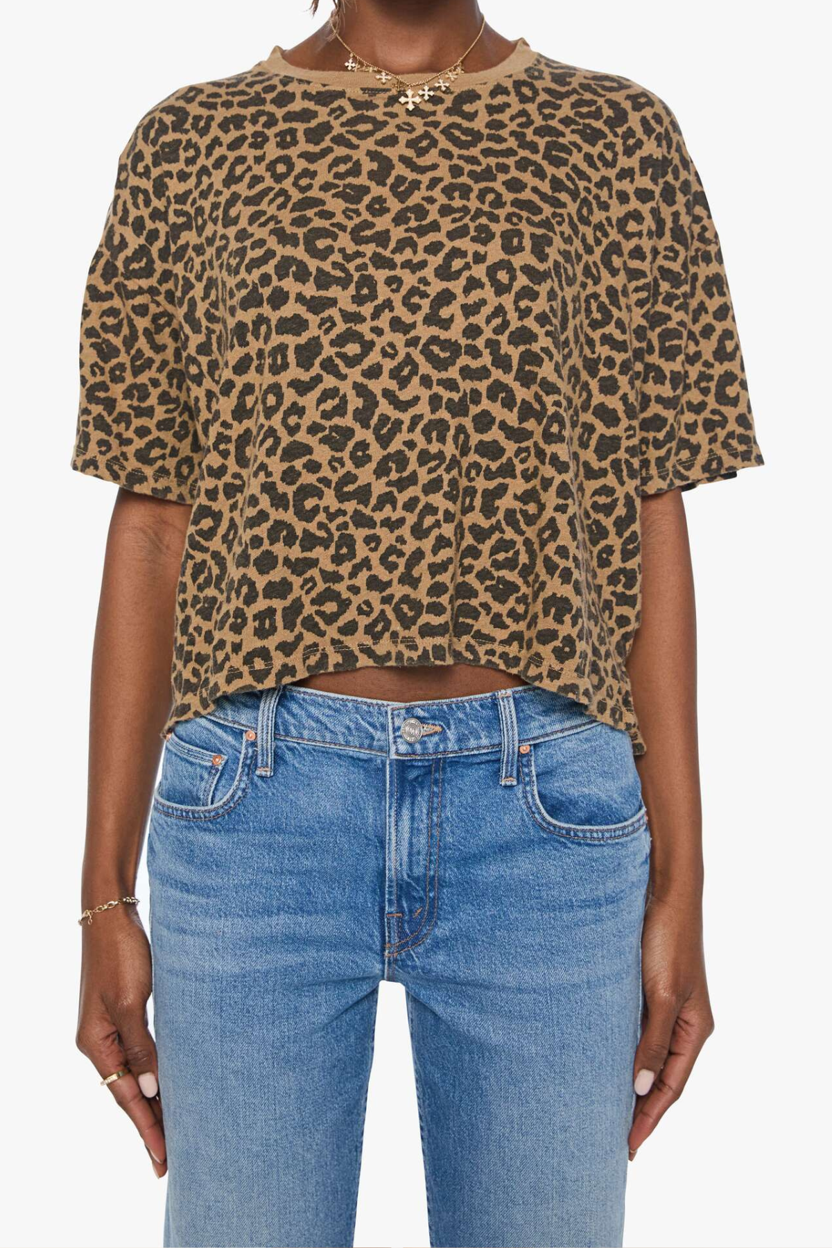 Model wearing a brown striped short-sleeve boxy ringer T-shirt with contrast trim and blue denim.