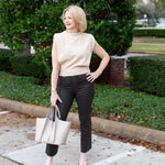 Sleeveless knit muscle sweater vest styled with trousers